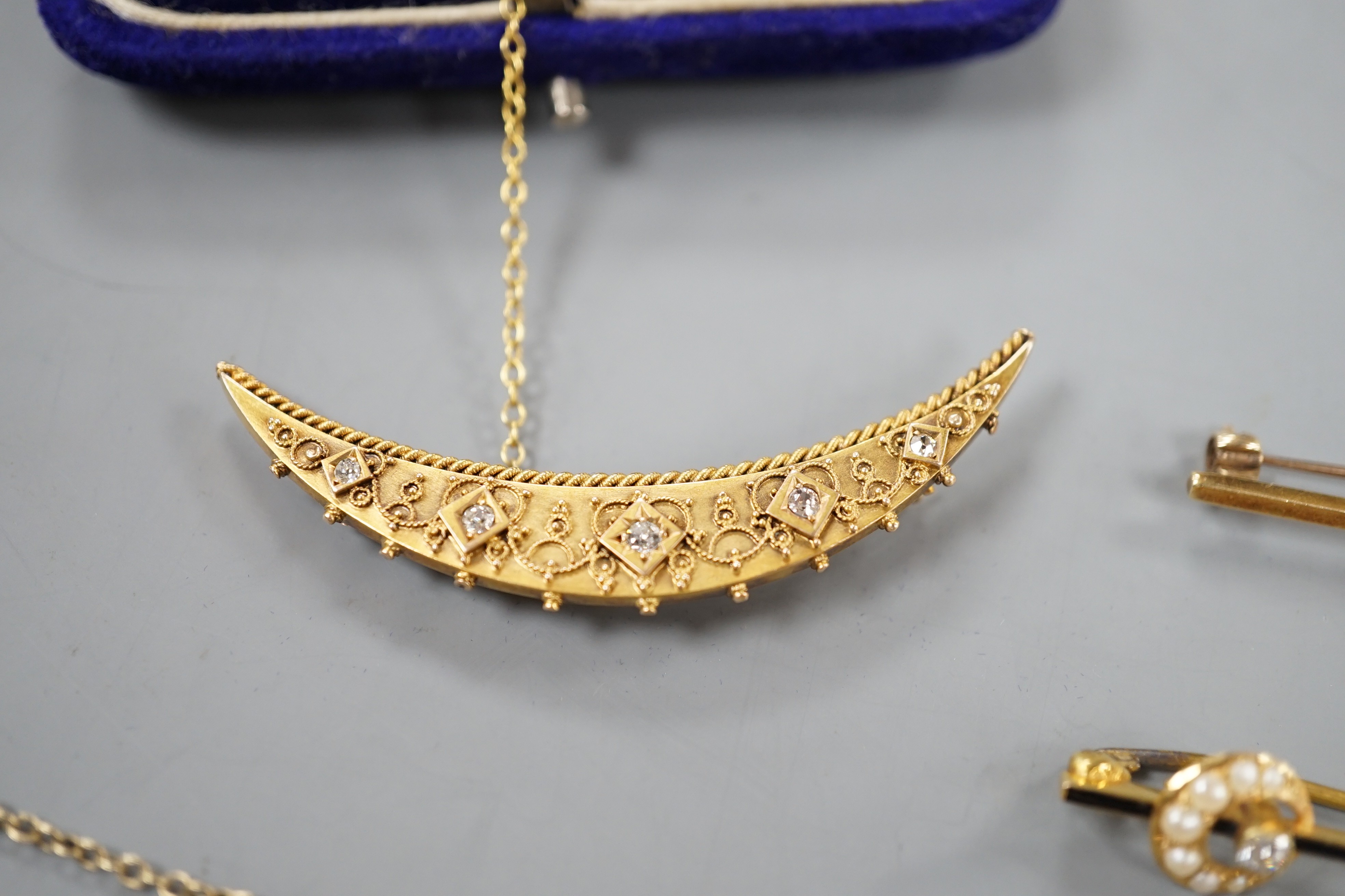 Two assorted late 19th/early 20th century 15ct, diamond and seed pearl set bar brooches including crescent, 53mm and enamel and crescent, gross7 grams, and three other bar brooches, diamond set and seed pearl set, gross